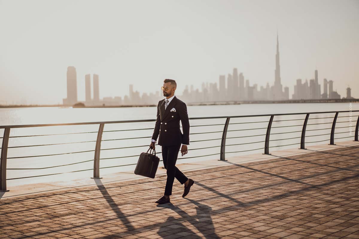 brioni-man-walking-next-to-a-river-skyline-man-wearing-suit