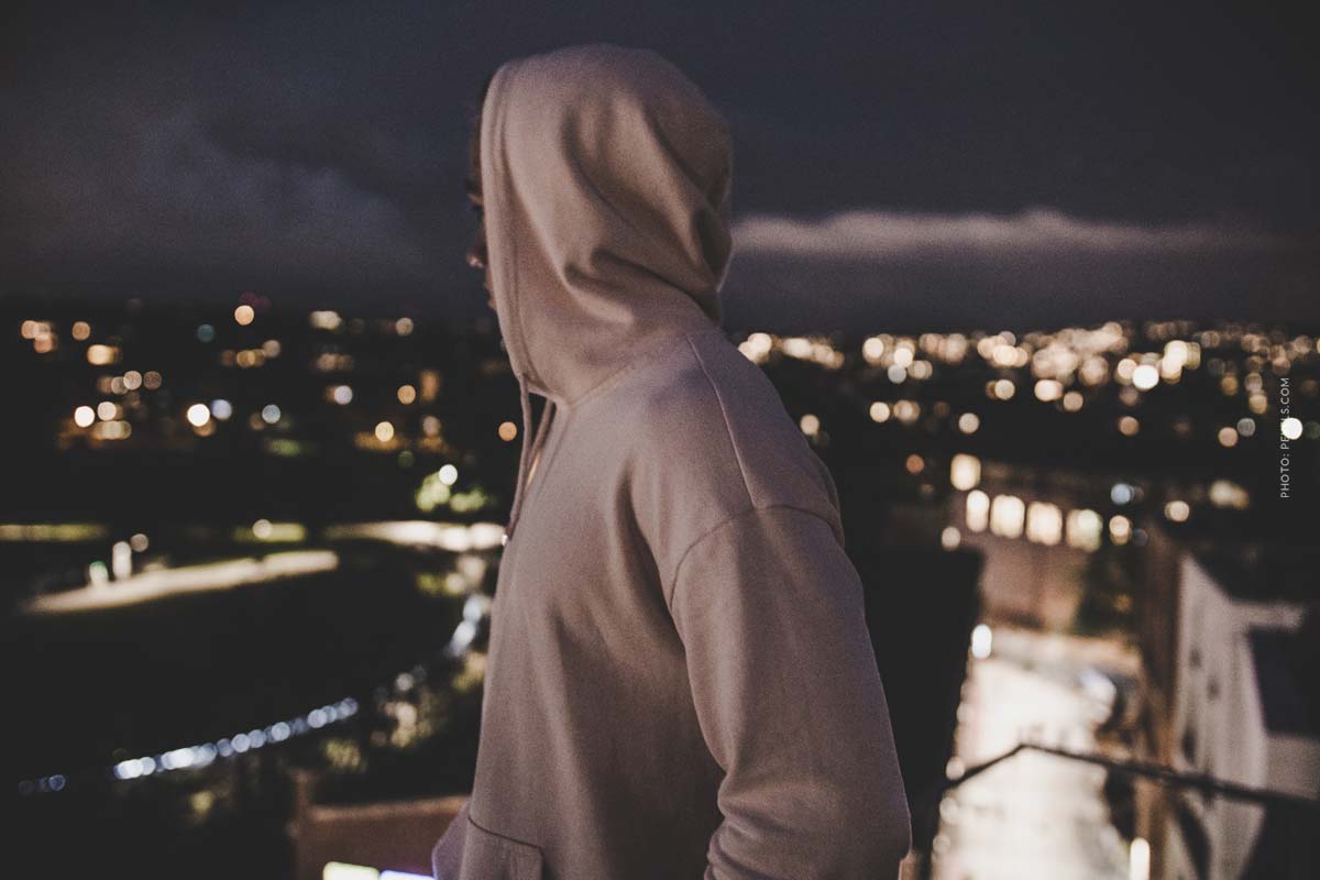fashion-brand-stone-island-streetwear-man-standing-on-roof-in-a-hoodie